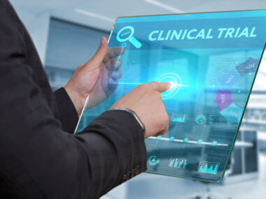 AADvac1 | Alzheimer's News Today | Clinical Trials | Photo of man's arms holding a transparent computer tablet