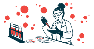 A researchers works with petri dishes in a lab, alongside a rack of vials filled with blood.