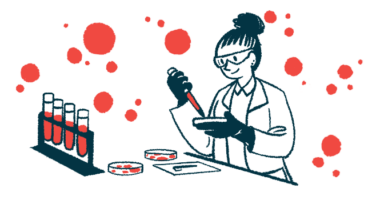 A researchers works with petri dishes in a lab, alongside a rack of vials filled with blood.